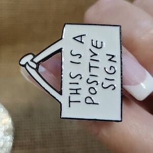 POSITIVE SIGN PIN
